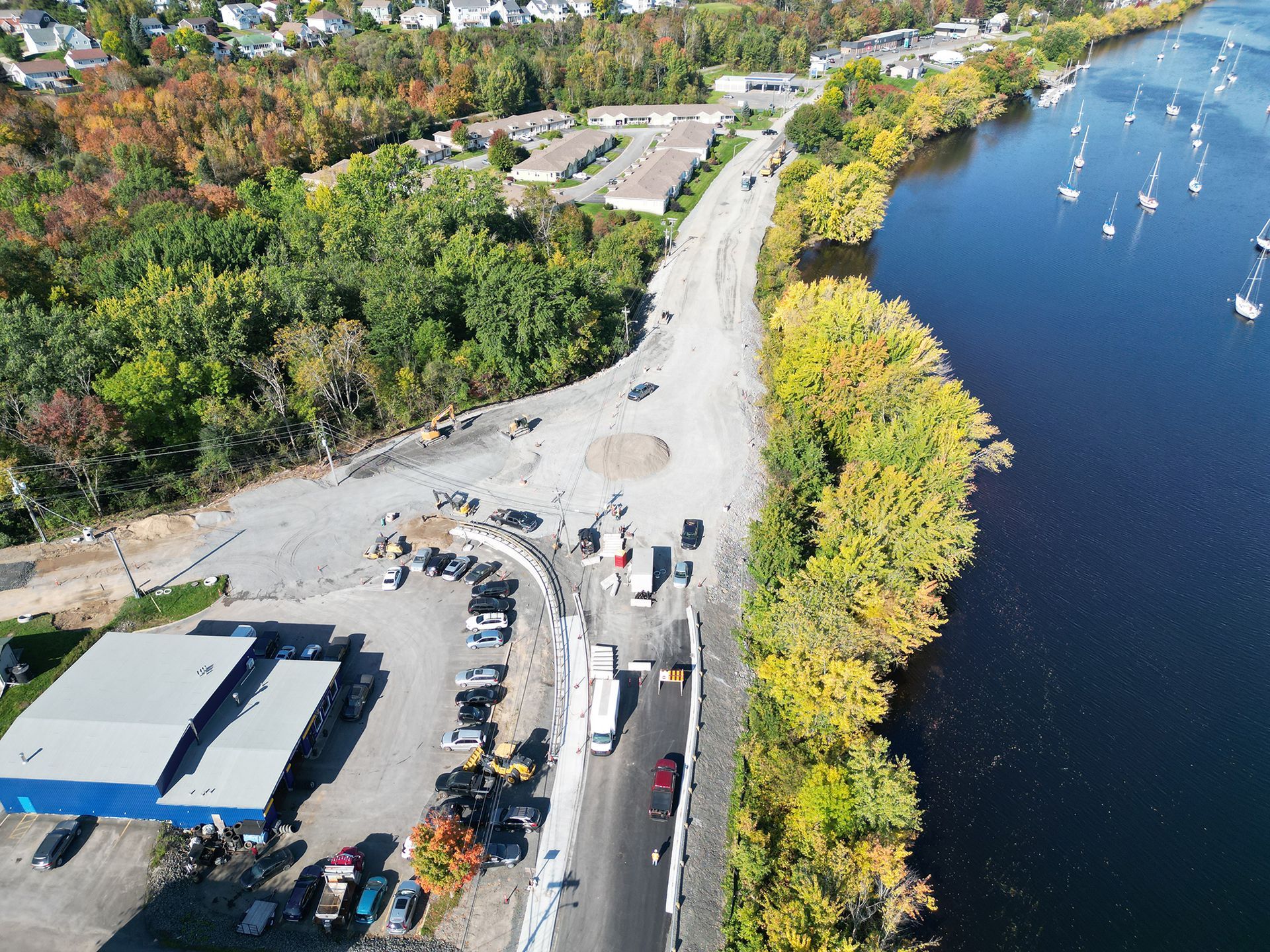 An aerial view of a road next to a body of water
