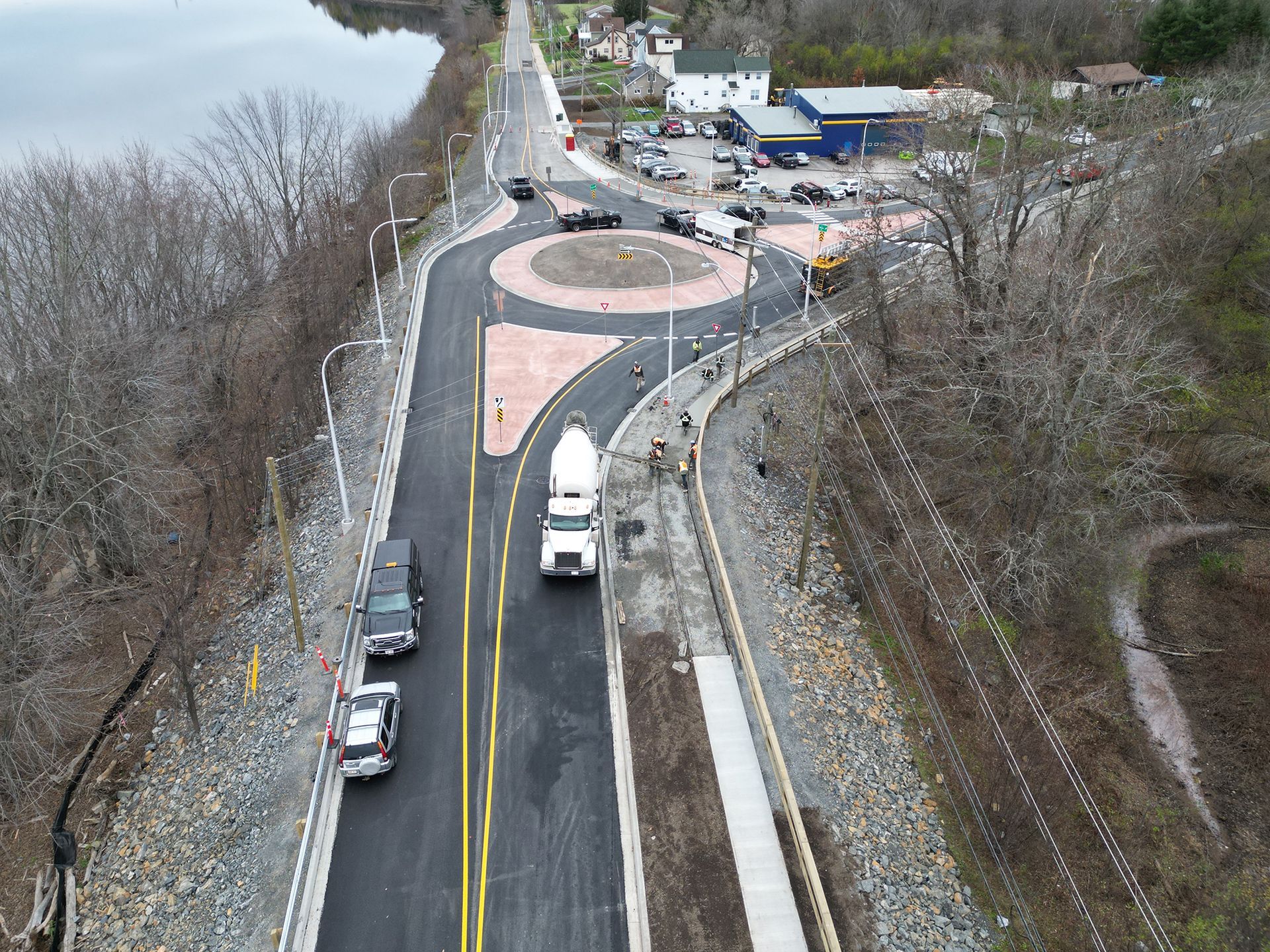 An aerial view of a road with a roundabout in the middle
