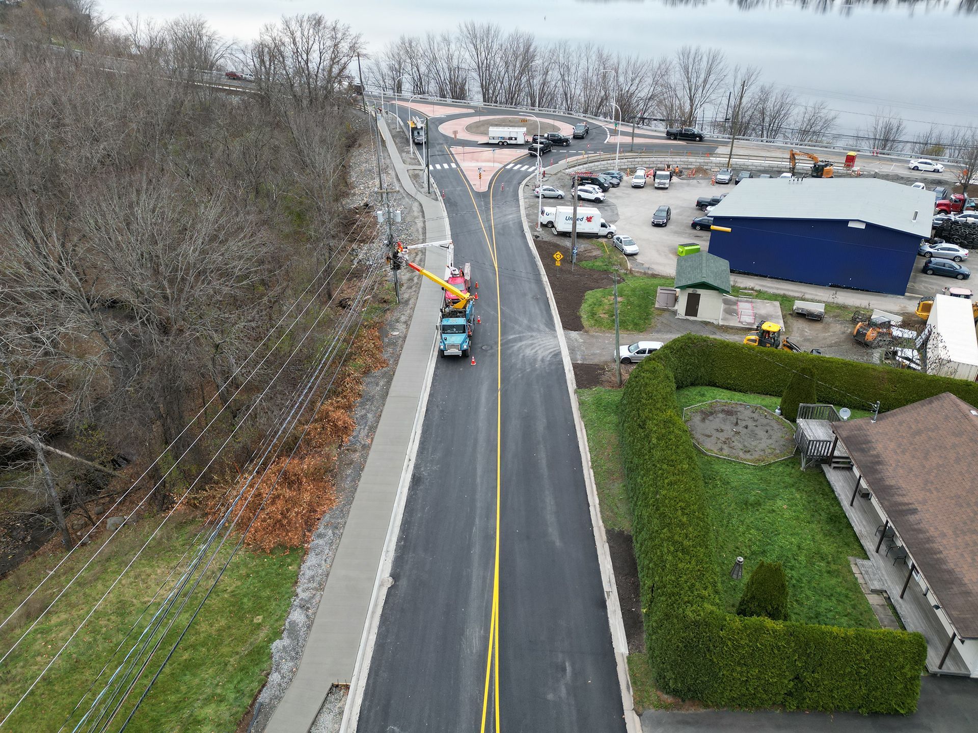An aerial view of a road with a truck driving down it.