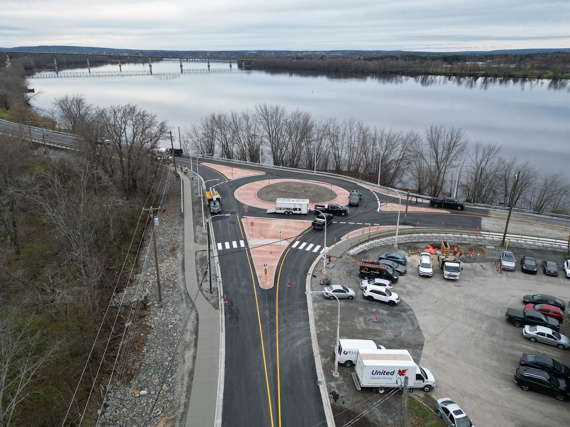 An aerial view of a roundabout with a river in the background.