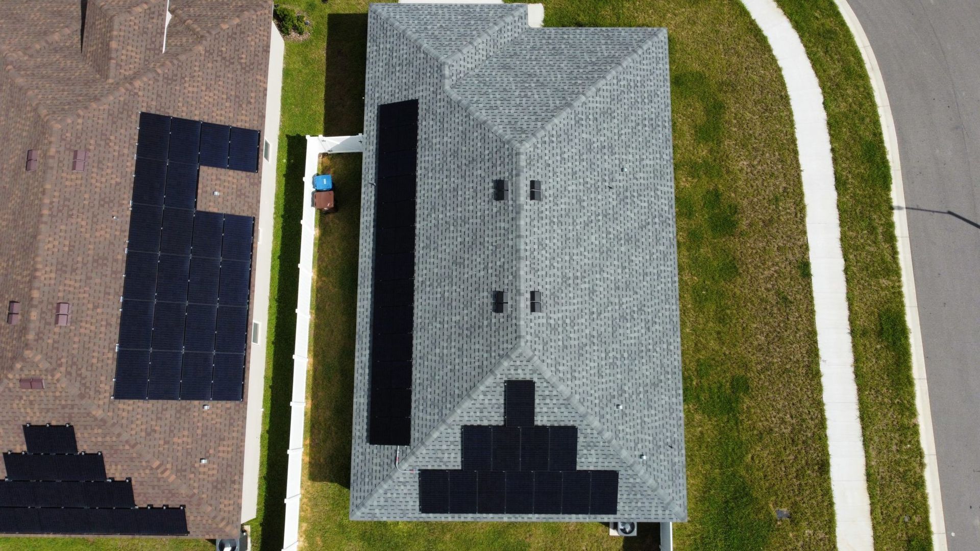 An aerial view of a house with solar panels on the roof.