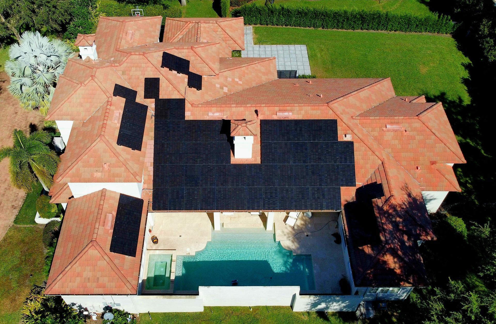 An aerial view of a house with solar panels on the roof