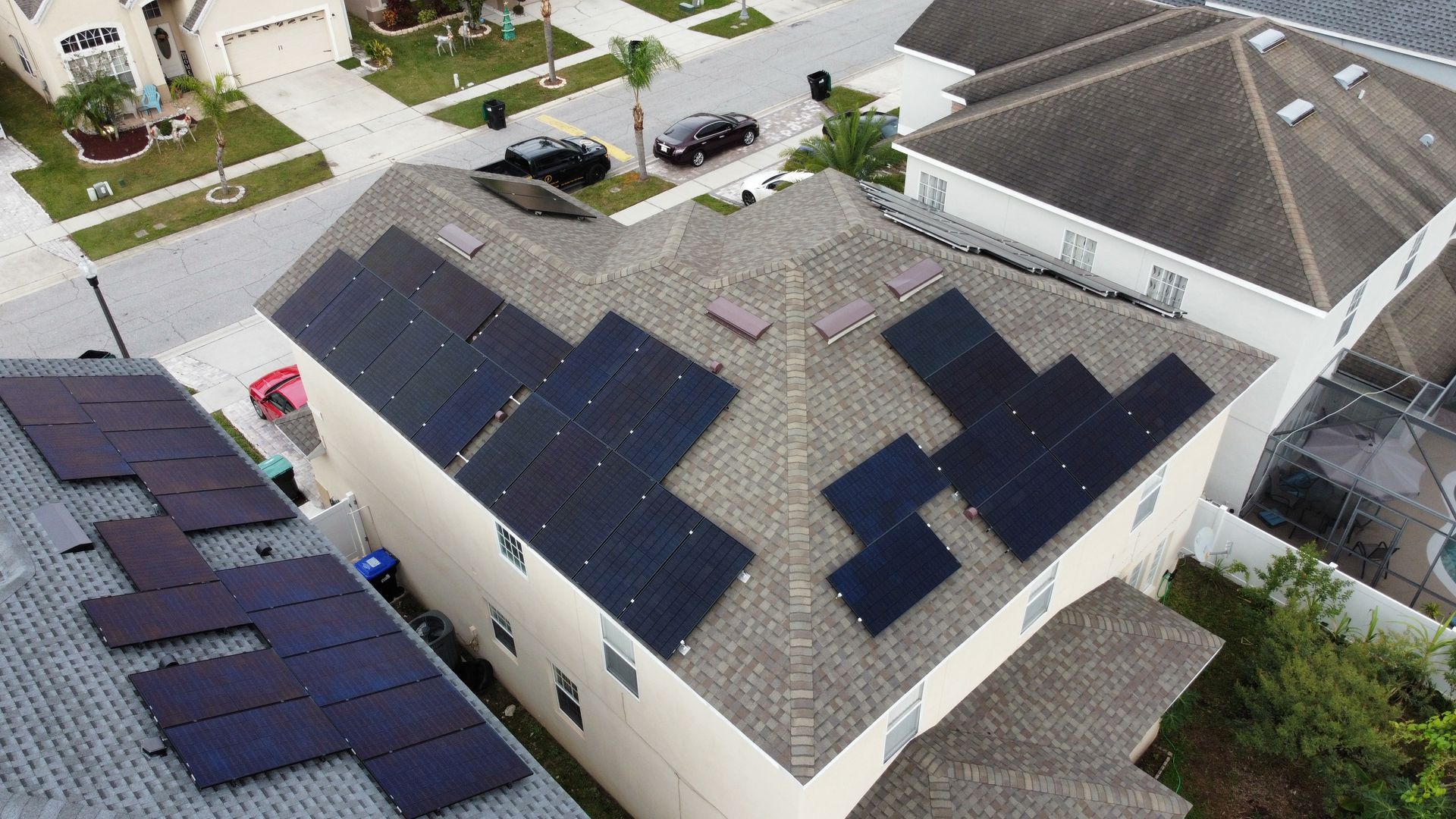 An aerial view of a house with solar panels on the roof.