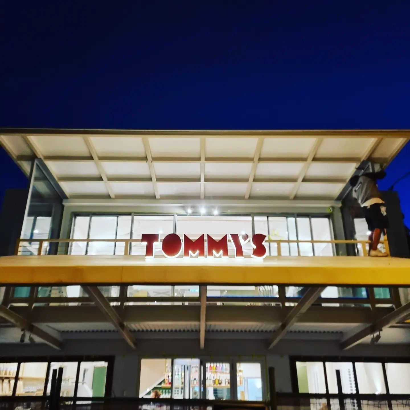 A Tommy 's Store Is Lit up At Night — Goldspark GC Electrical in Burleigh Waters, QLD