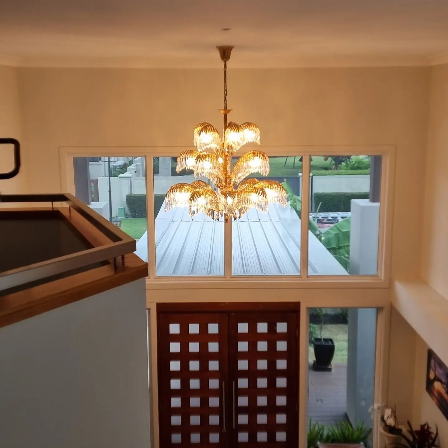 A Chandelier Hangs from The Ceiling Above a Doorway — Goldspark GC Electrical in Currumbin, QLD