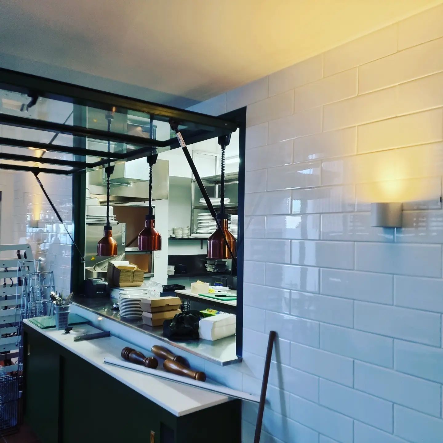 A Kitchen with White Brick Walls and A Large Window — Goldspark GC Electrical in Burleigh Waters, QLD