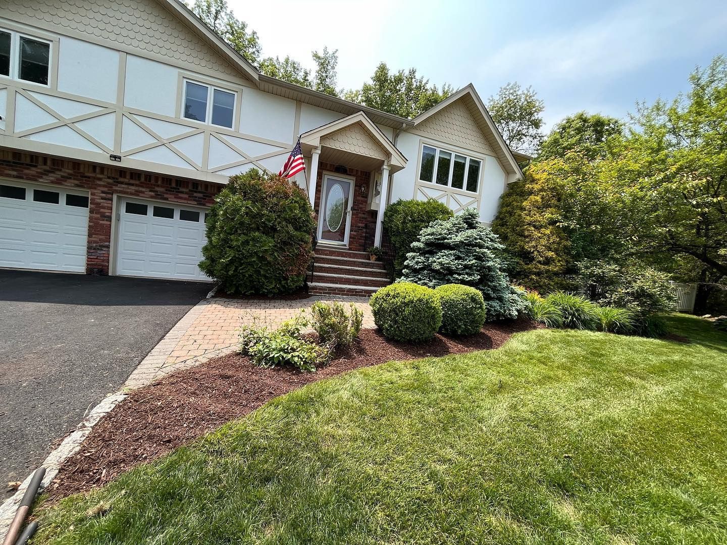 A large house with a lush green lawn in front of it.