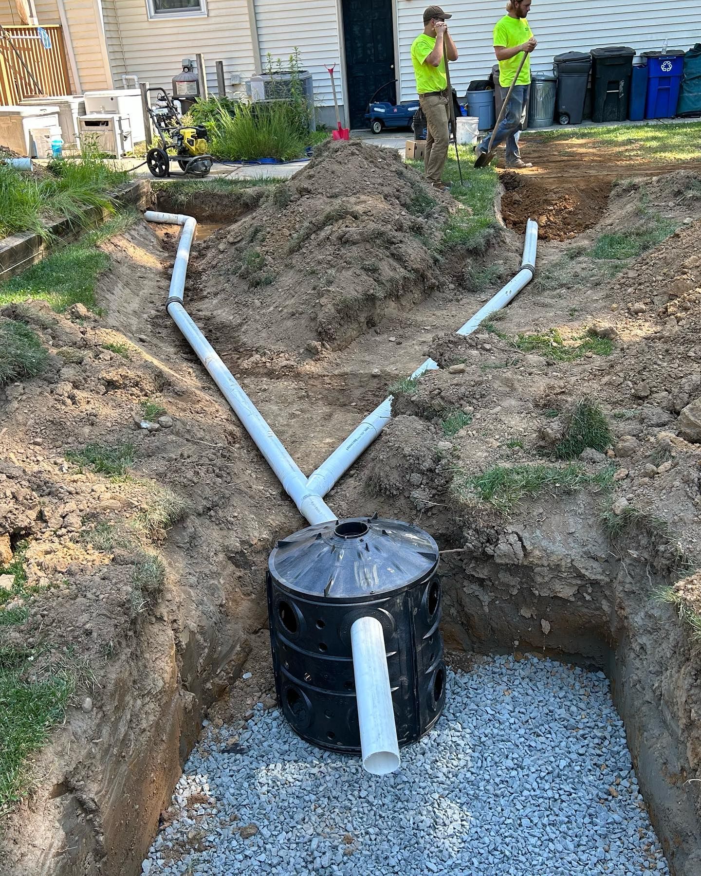 A septic tank is being installed in a backyard.