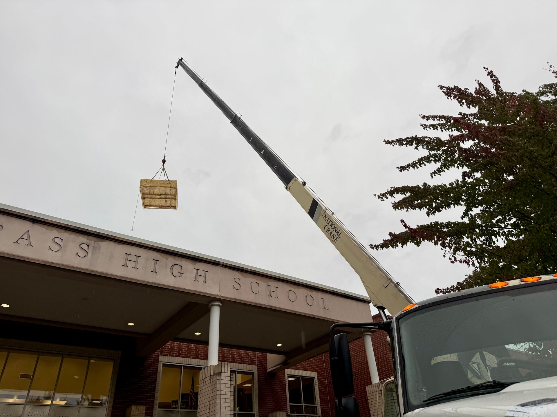 A crane lifting a wooden crate near
