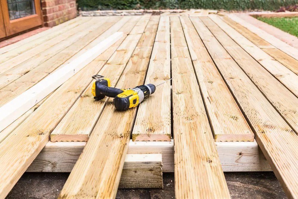 A Drill Is Sitting on Top of A Wooden Deck — Manning Valley Patios in Cundletown, NSW