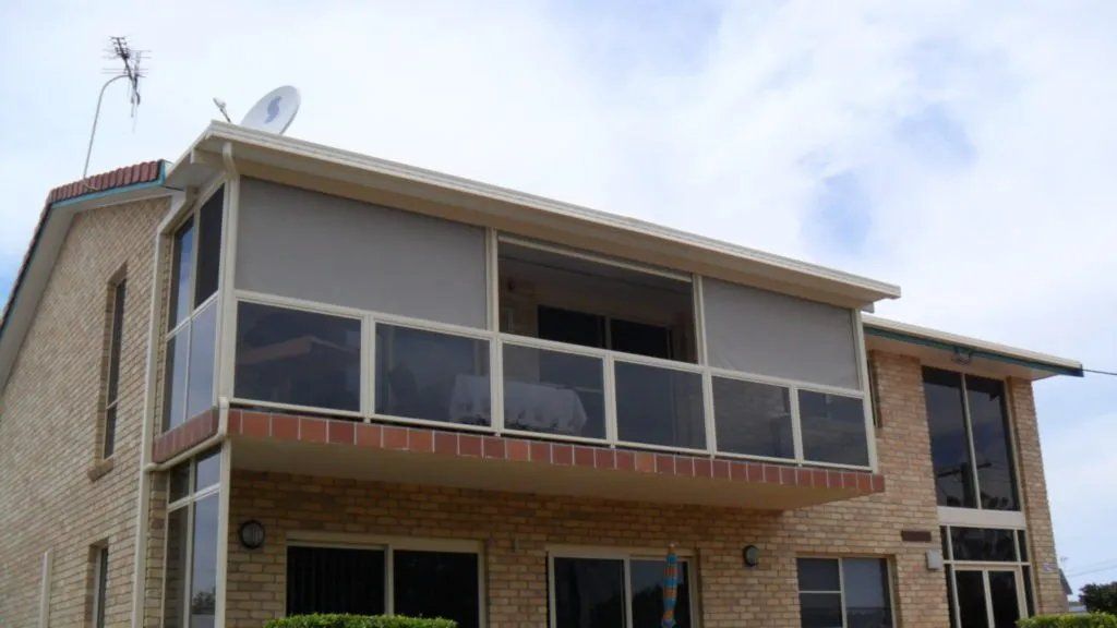 A Large Brick House with A Balcony a nd A Satellite Dish on The Roof — Manning Valley Patios in Cundletown, NSW