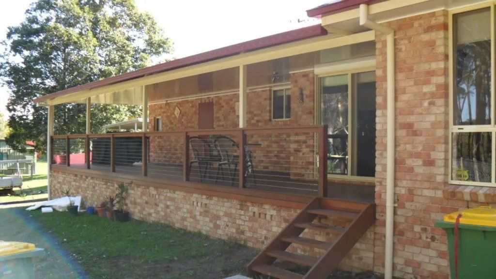 A Brick House with A Large Porch and Stairs — Manning Valley Patios in Harrington, NSW
