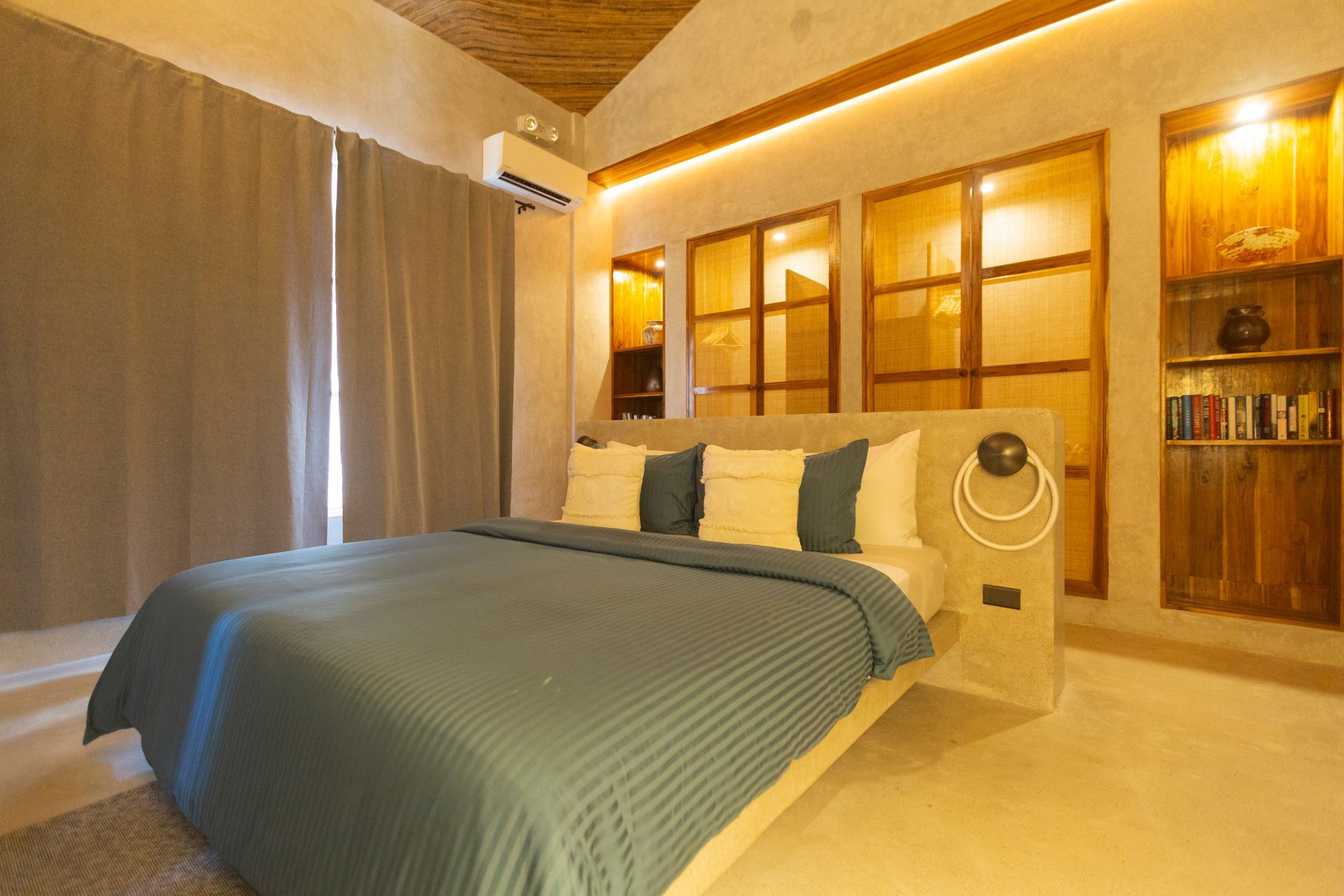 Bedroom with a large bed, wooden accents, and a neutral color scheme.