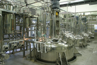 Image of stainless-steel bioreactors in a biopharma suite