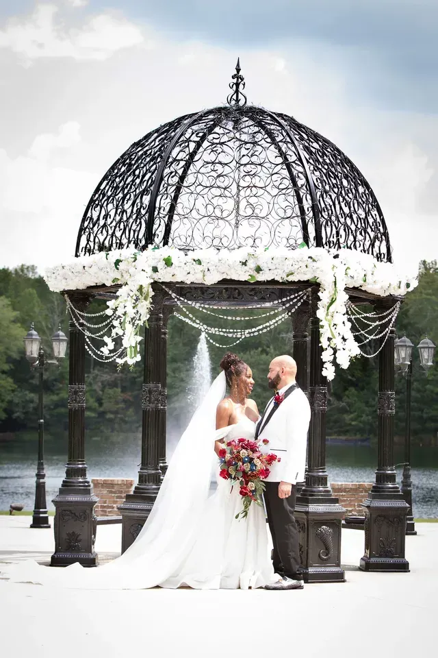 A Bride and Groom are Posing for a Picture in Front of a Gazebo — Atlanta, GA — Pristine Chapel