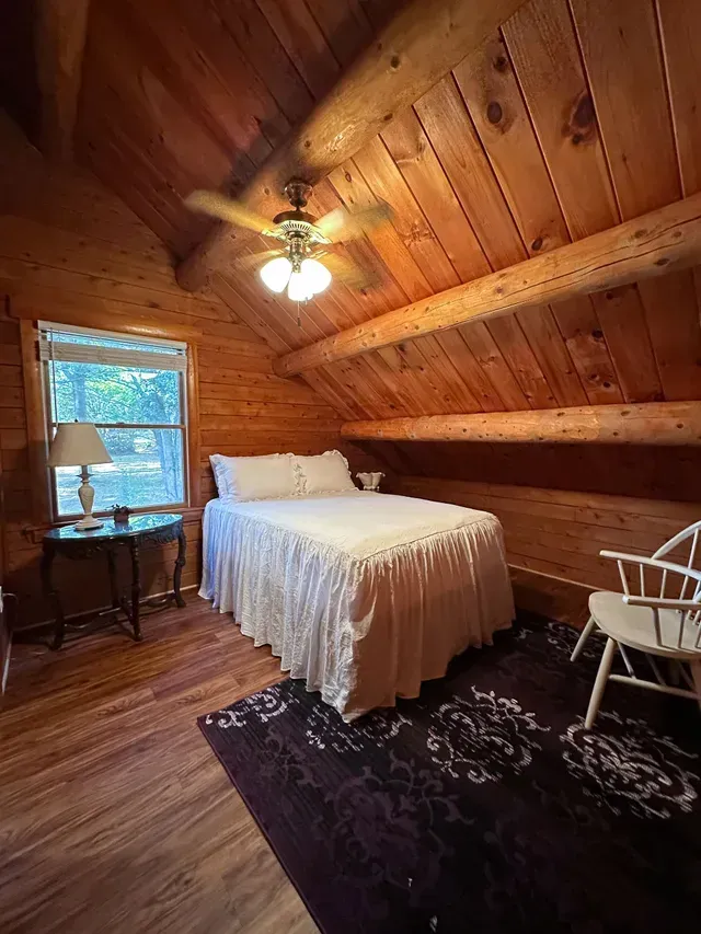 Cabin Bedroom With White Bed — Atlanta, GA — Pristine Chapel