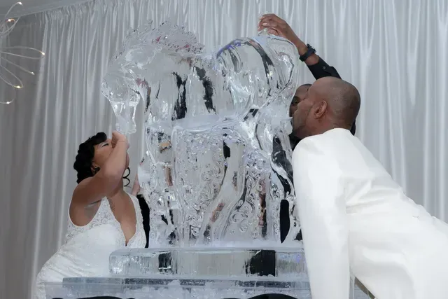 A Bride and Groom Drinking on Ice Sculpture — Atlanta, GA — Pristine Chapel