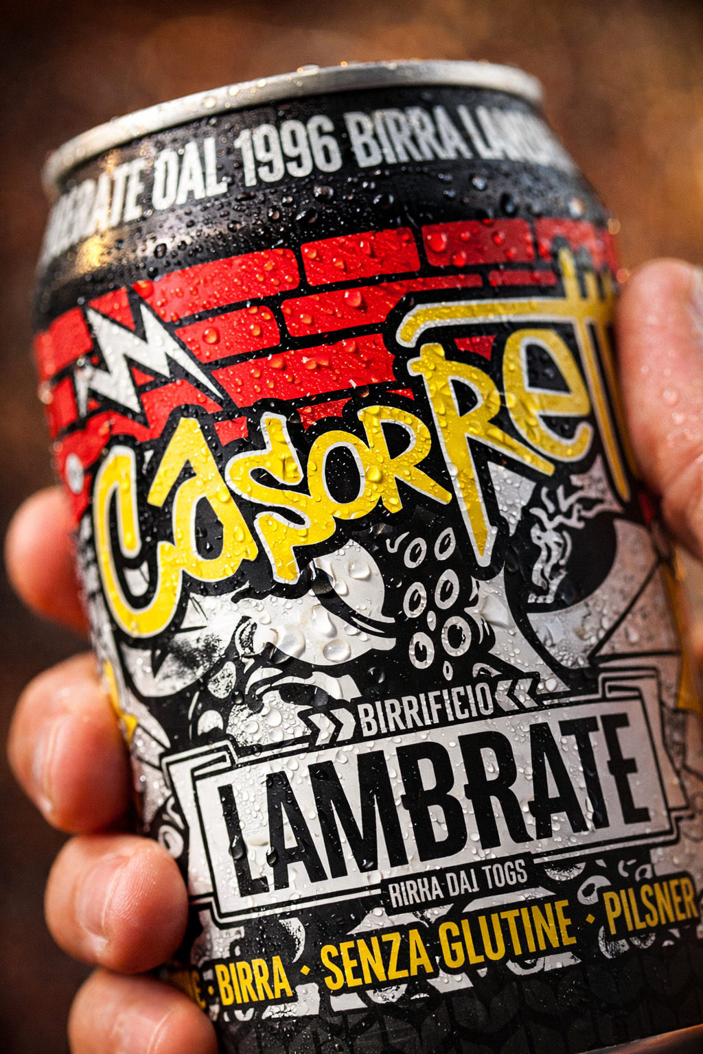 A hand holding a can of