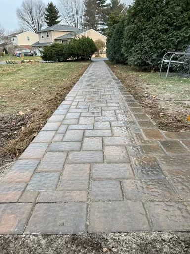 A Brick Walkway Leading to A House in A Residential Area.