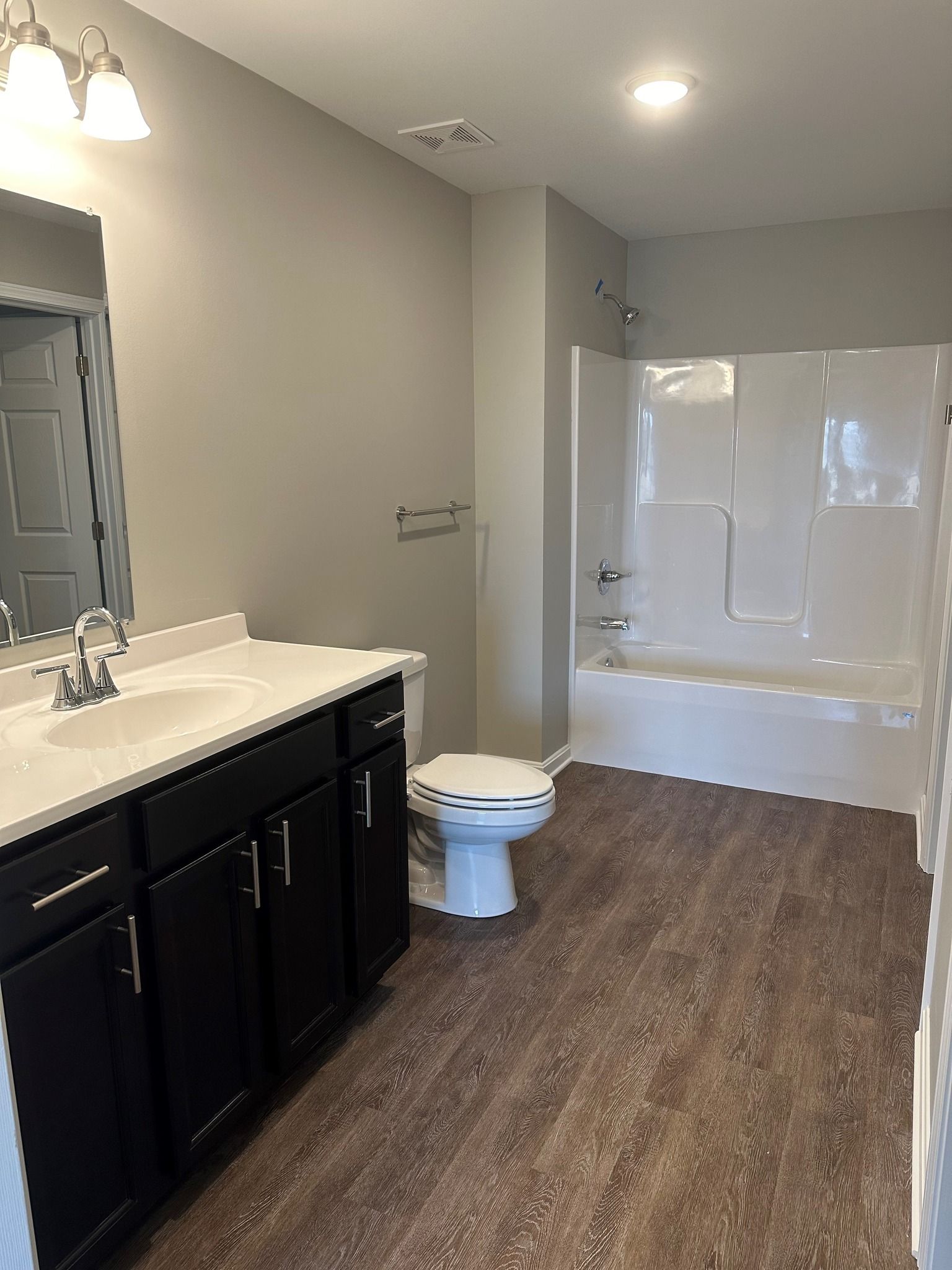 A bathroom with a toilet , sink , and bathtub.