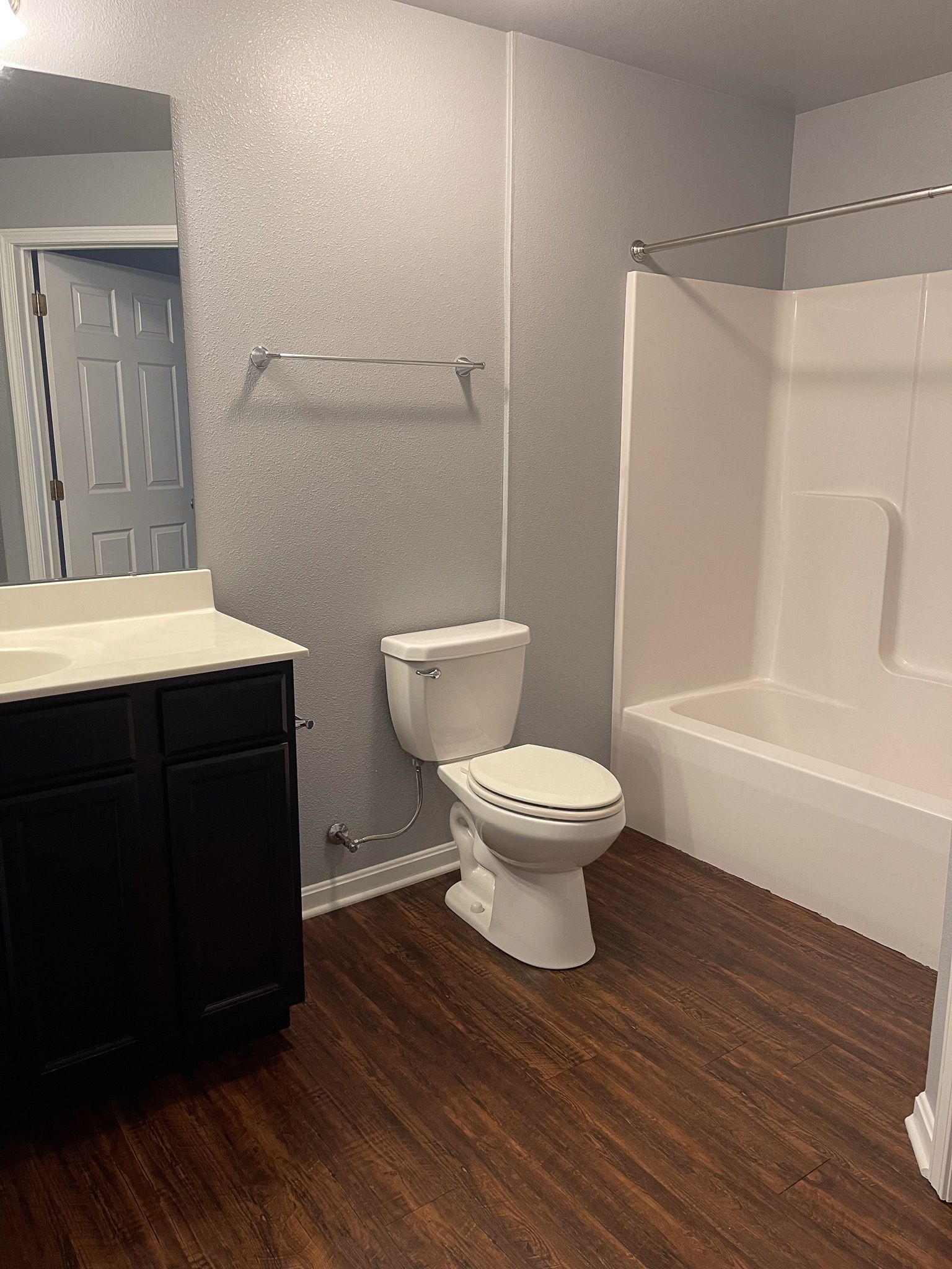 A bathroom with a toilet , sink , and bathtub.
