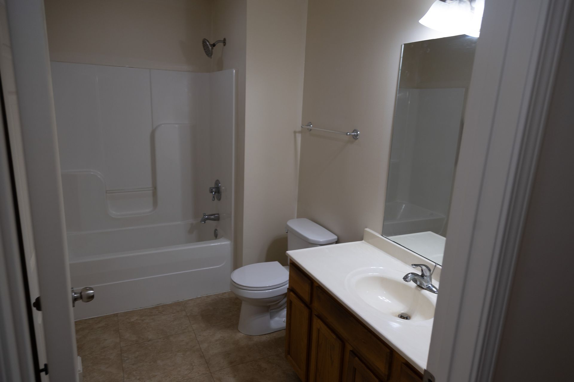 A bathroom with a toilet , sink , and bathtub.