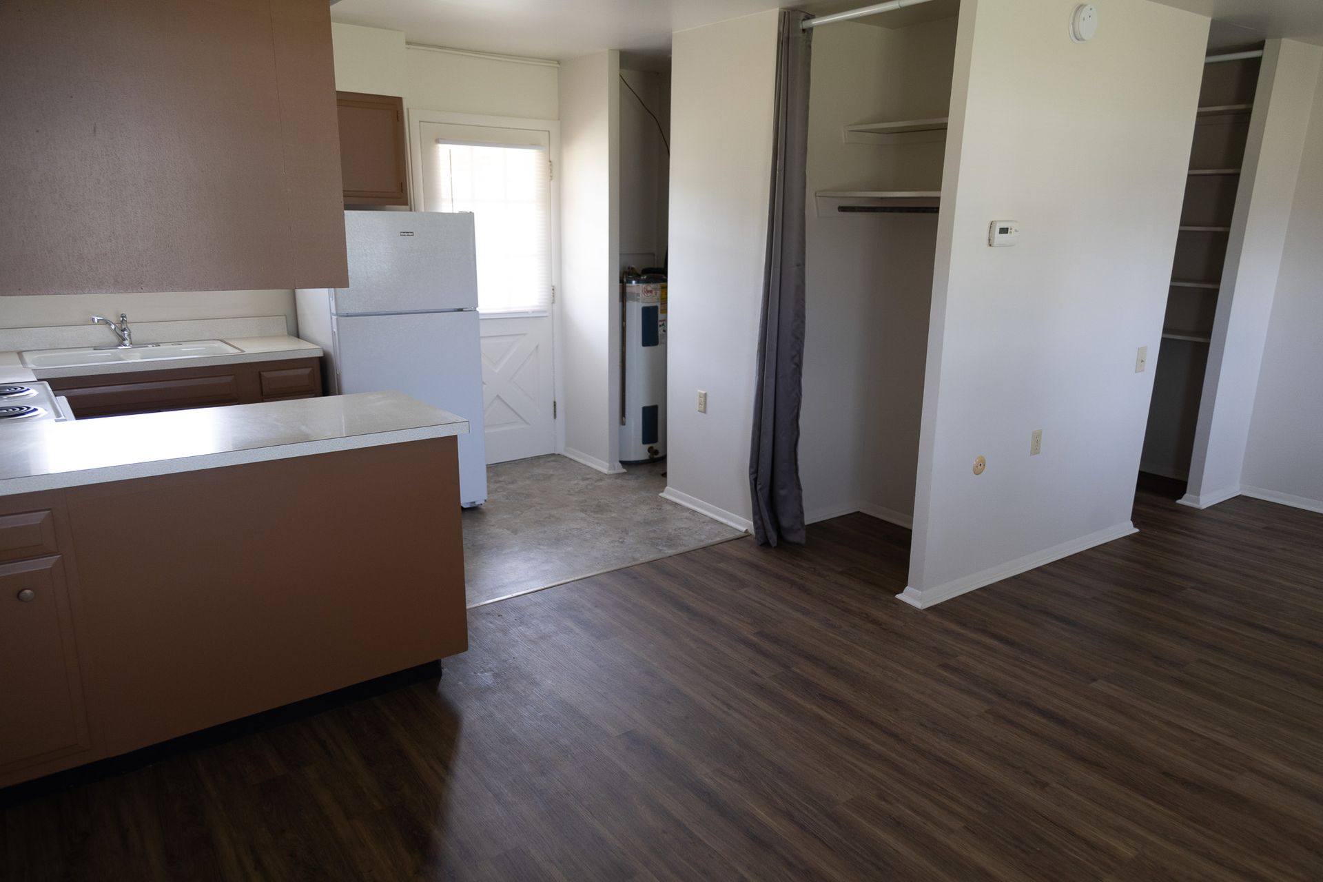 A kitchen with a refrigerator and a stove in it
