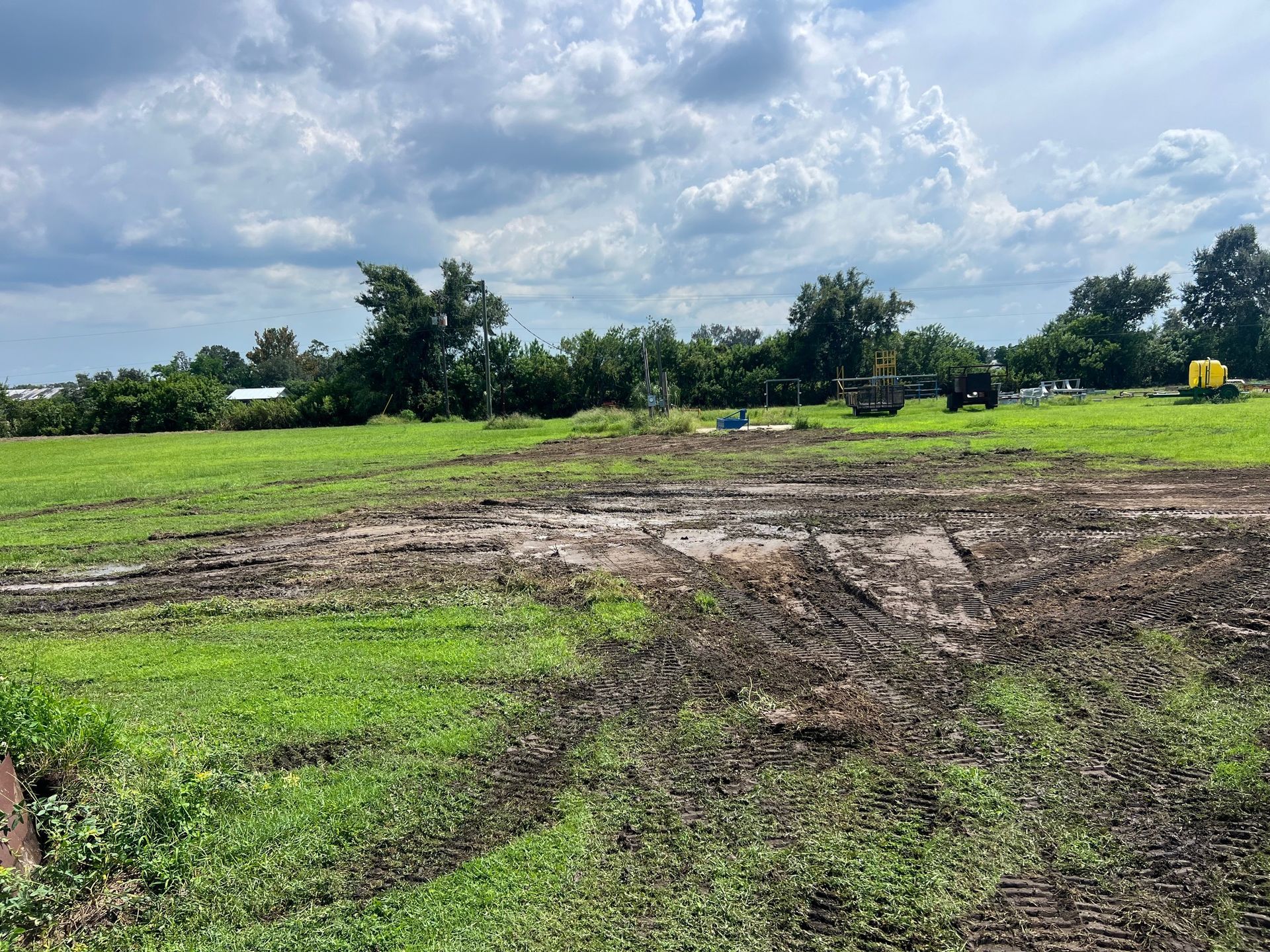 Construction site with exposed hillside covered by protective fabric layers.