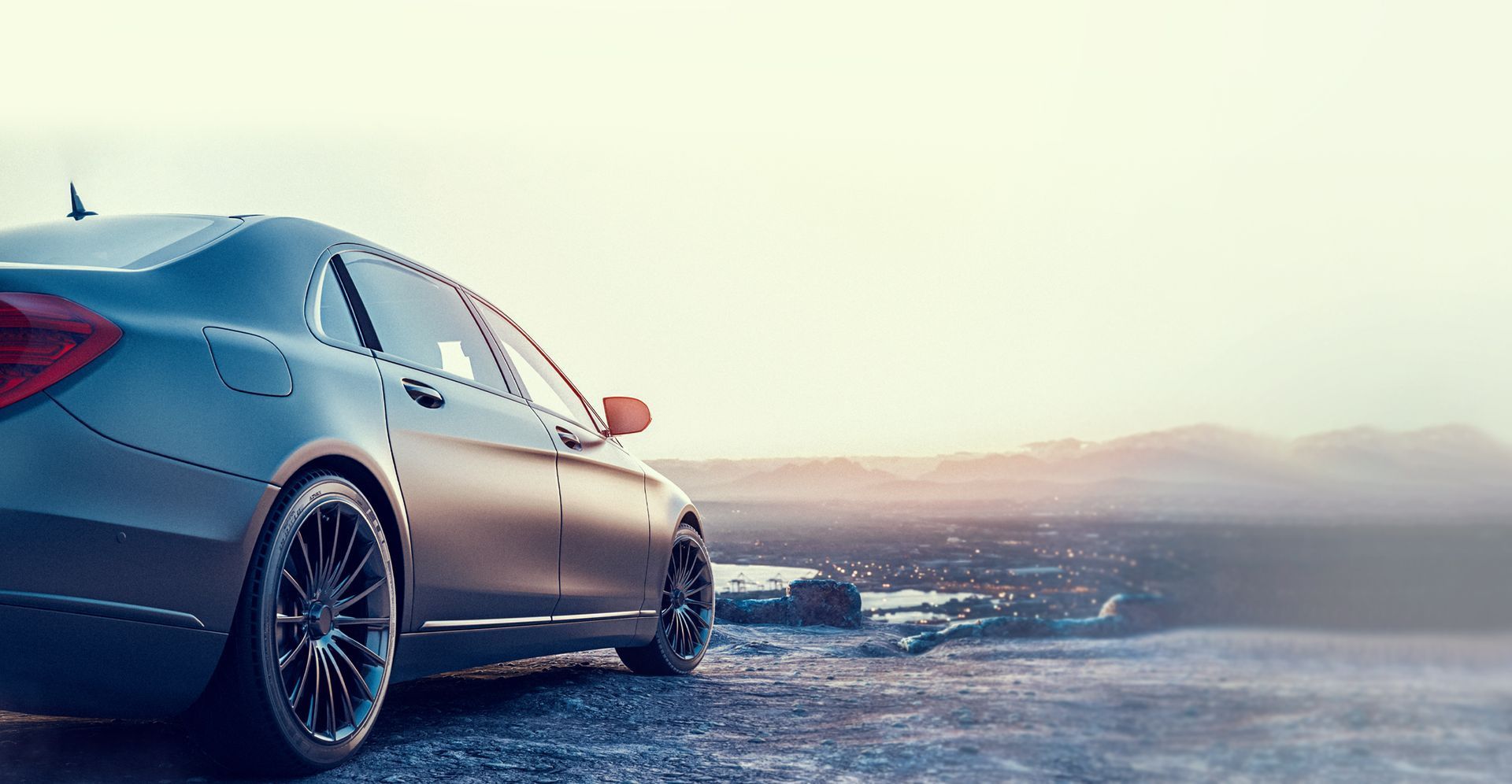 Gray car parked overlooking a city at sunset | Chief's Motor Group