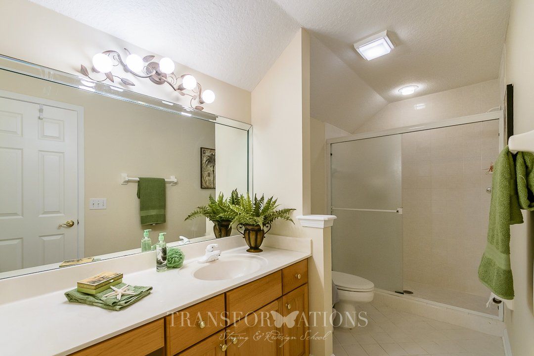 A bathroom with a sink , toilet , and shower.