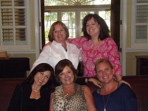 A group of women are posing for a picture together.