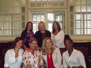 A group of women are posing for a picture together