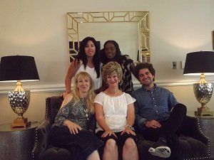 A group of people posing for a picture in a living room