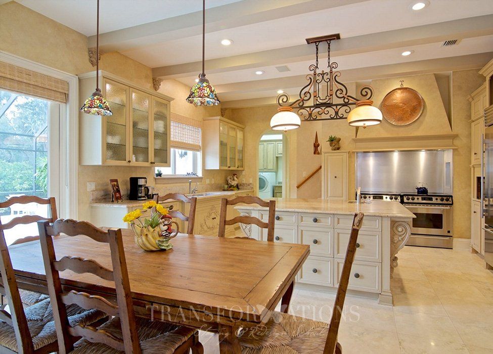 A kitchen with a table and chairs in it