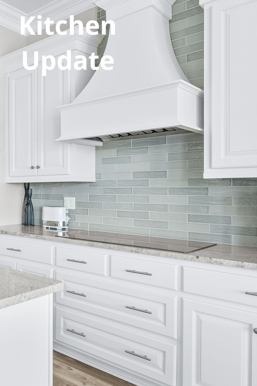 A kitchen with white cabinets and a stove top oven.