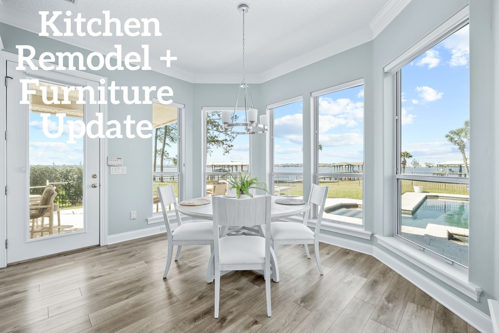 A kitchen with a table and chairs and a lot of windows.