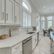 A kitchen with white cabinets and stainless steel appliances.