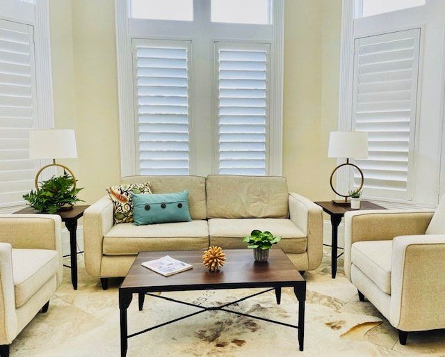 A living room with a couch , chairs and a coffee table