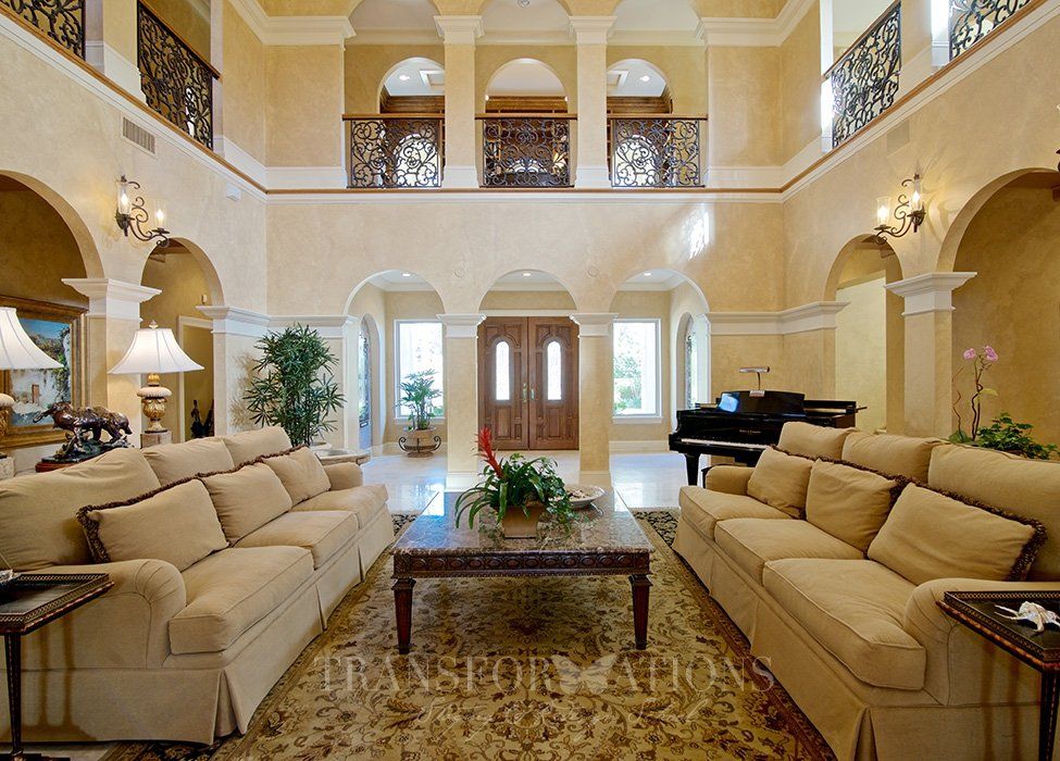 A living room with a piano and a couch that says ' luxury homes ' on it