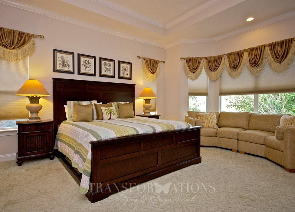 A bedroom with a king size bed and a couch