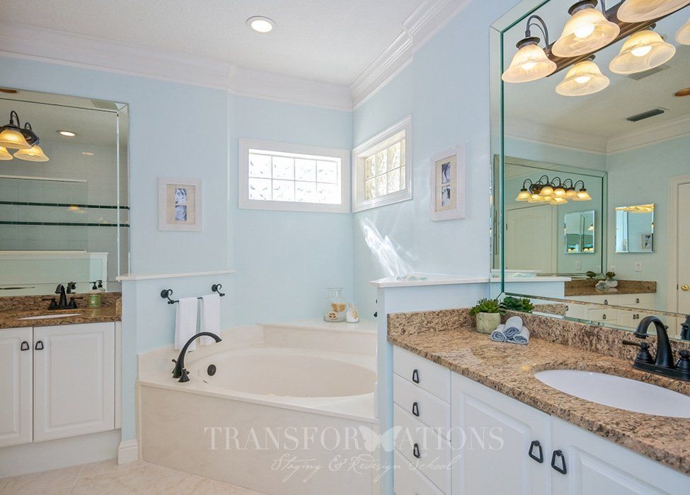 A bathroom with two sinks and a bathtub