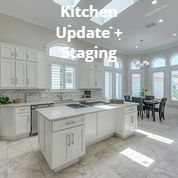 A kitchen with white cabinets and a large island.
