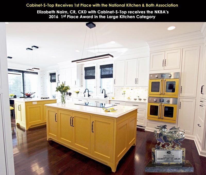 A picture of a kitchen with yellow cabinets and yellow ovens
