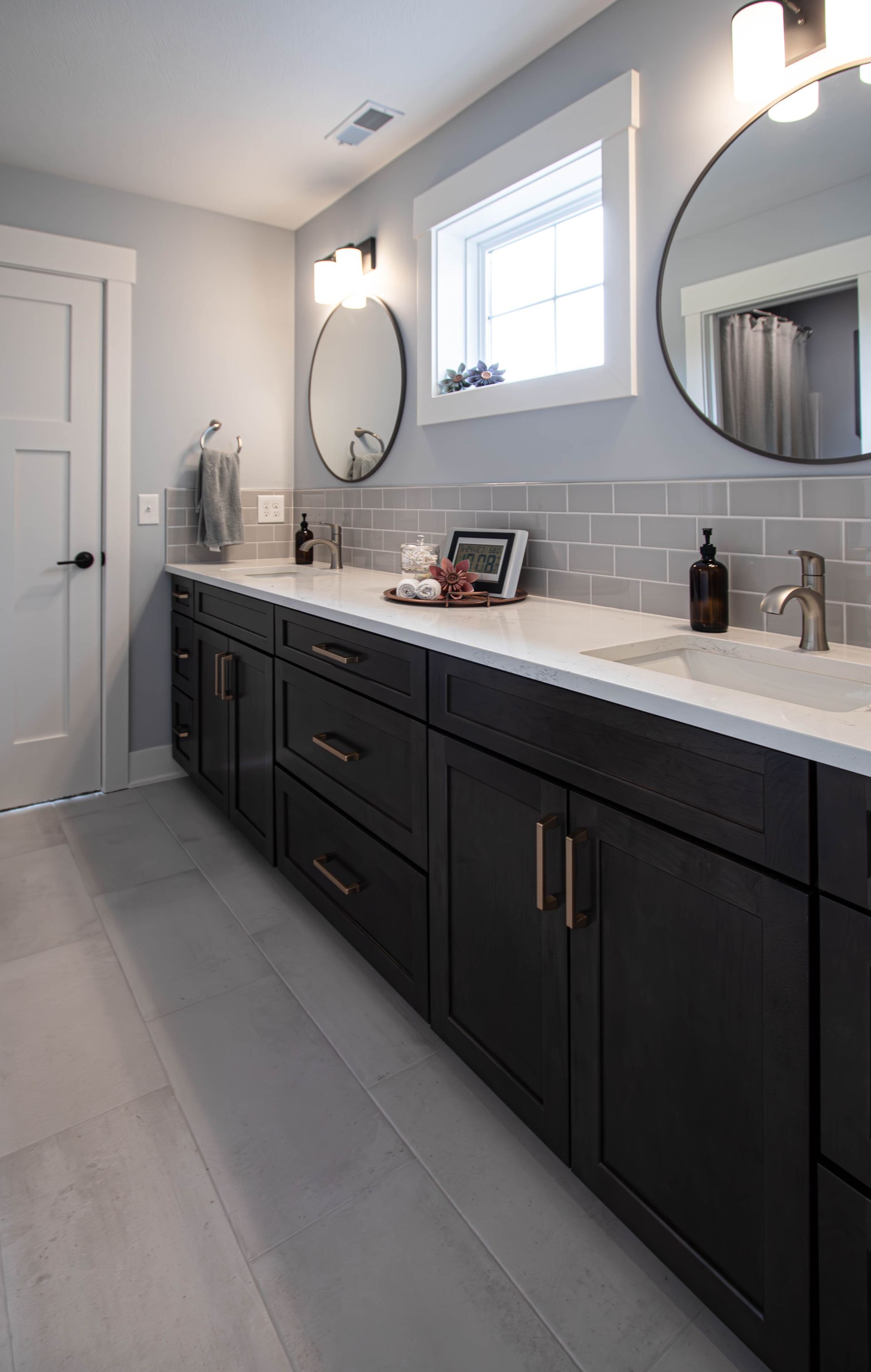 A bathroom with two sinks and two mirrors.