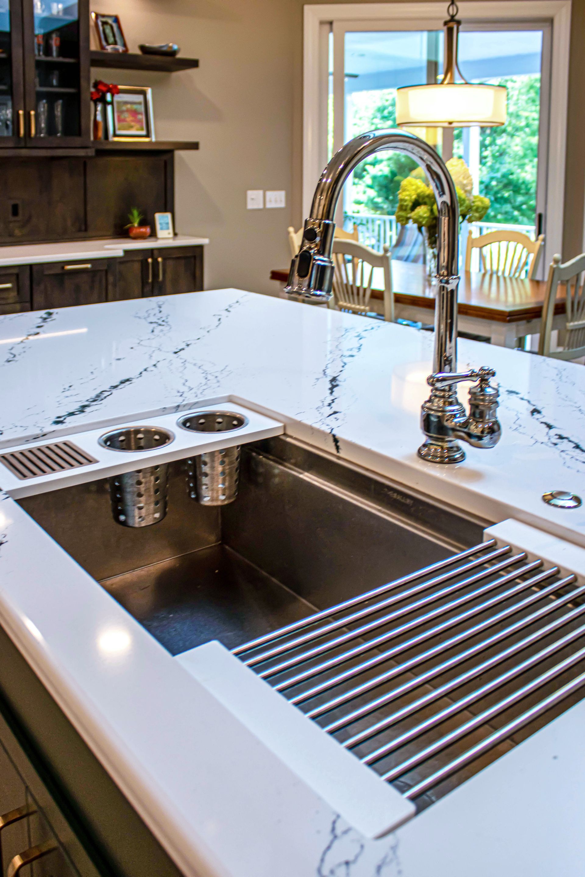 A kitchen with a stainless steel sink and a faucet.