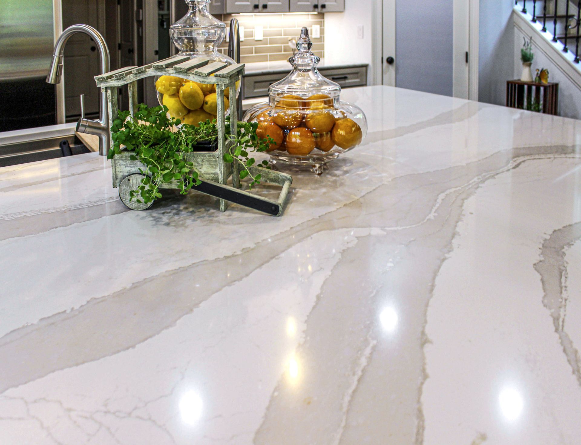 A kitchen counter with a bowl of lemons and oranges on it.