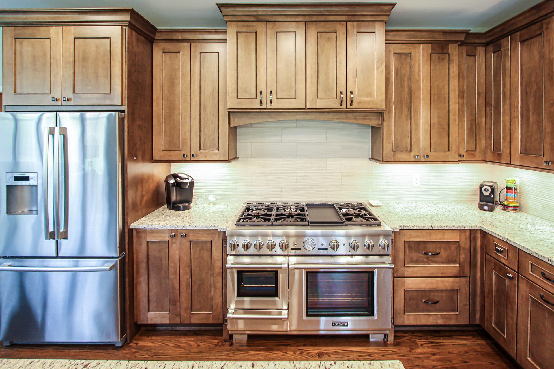 A kitchen with stainless steel appliances and wooden cabinets.