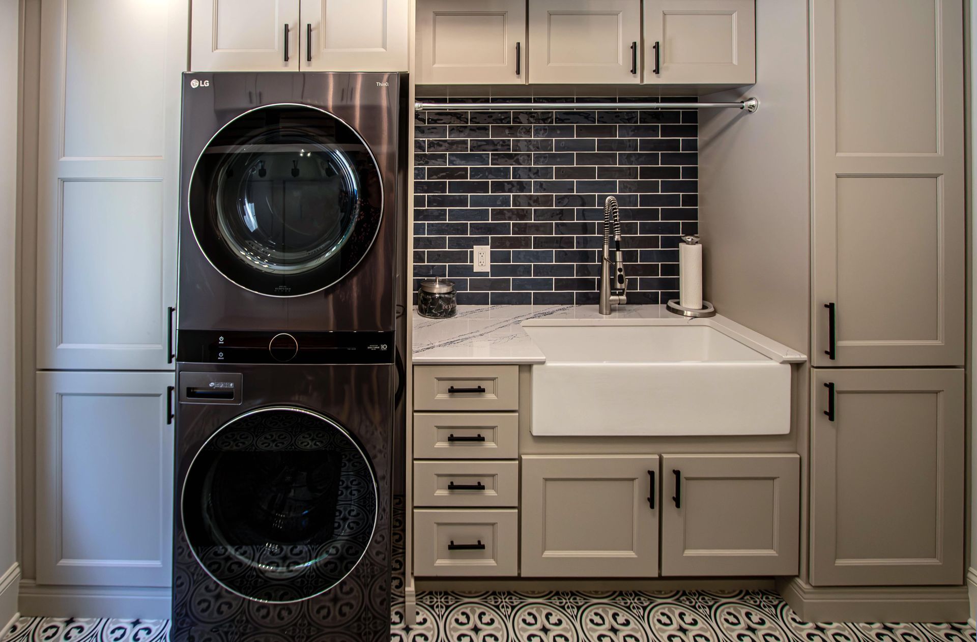 A laundry room with a washer and dryer stacked on top of each other.