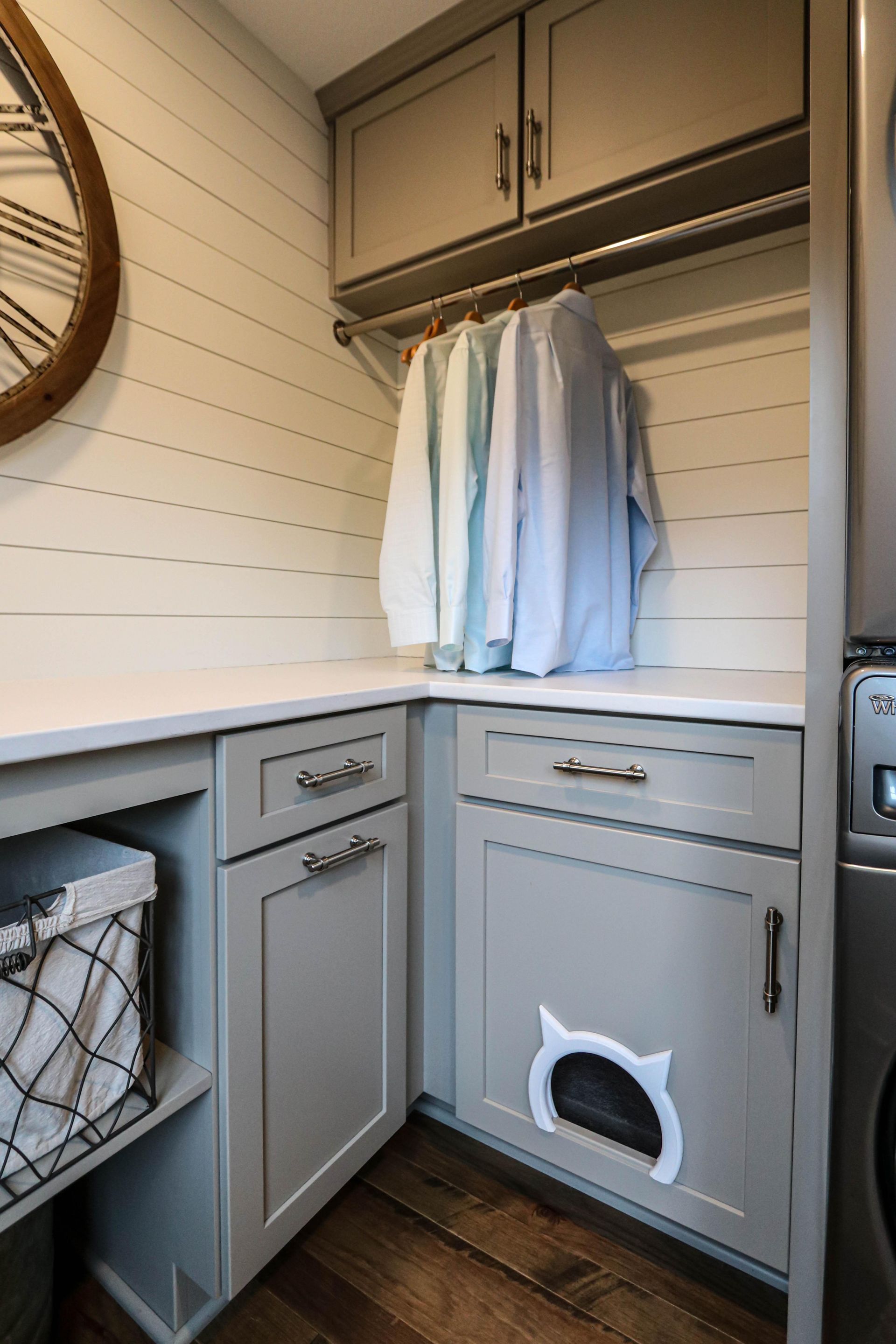 There is a cat litter box in the laundry room.