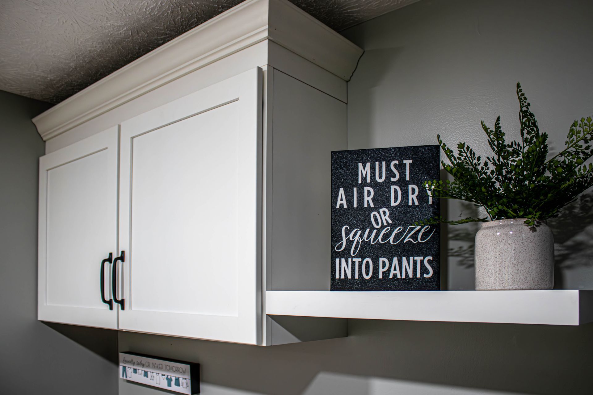 There is a sign on the shelf that says `` must air dry or squeeze into pants ''.